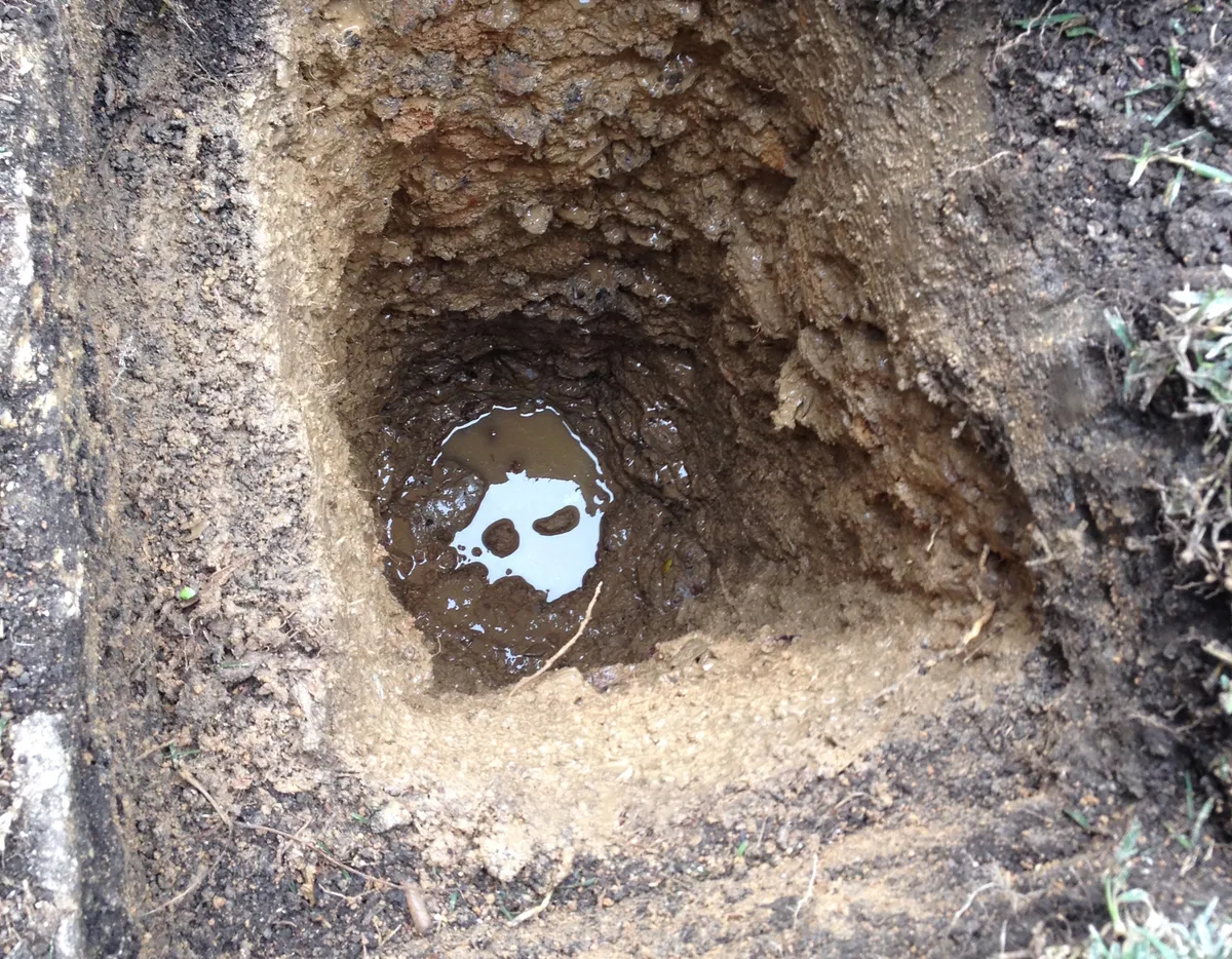 Water visible at bottom of excavation hole